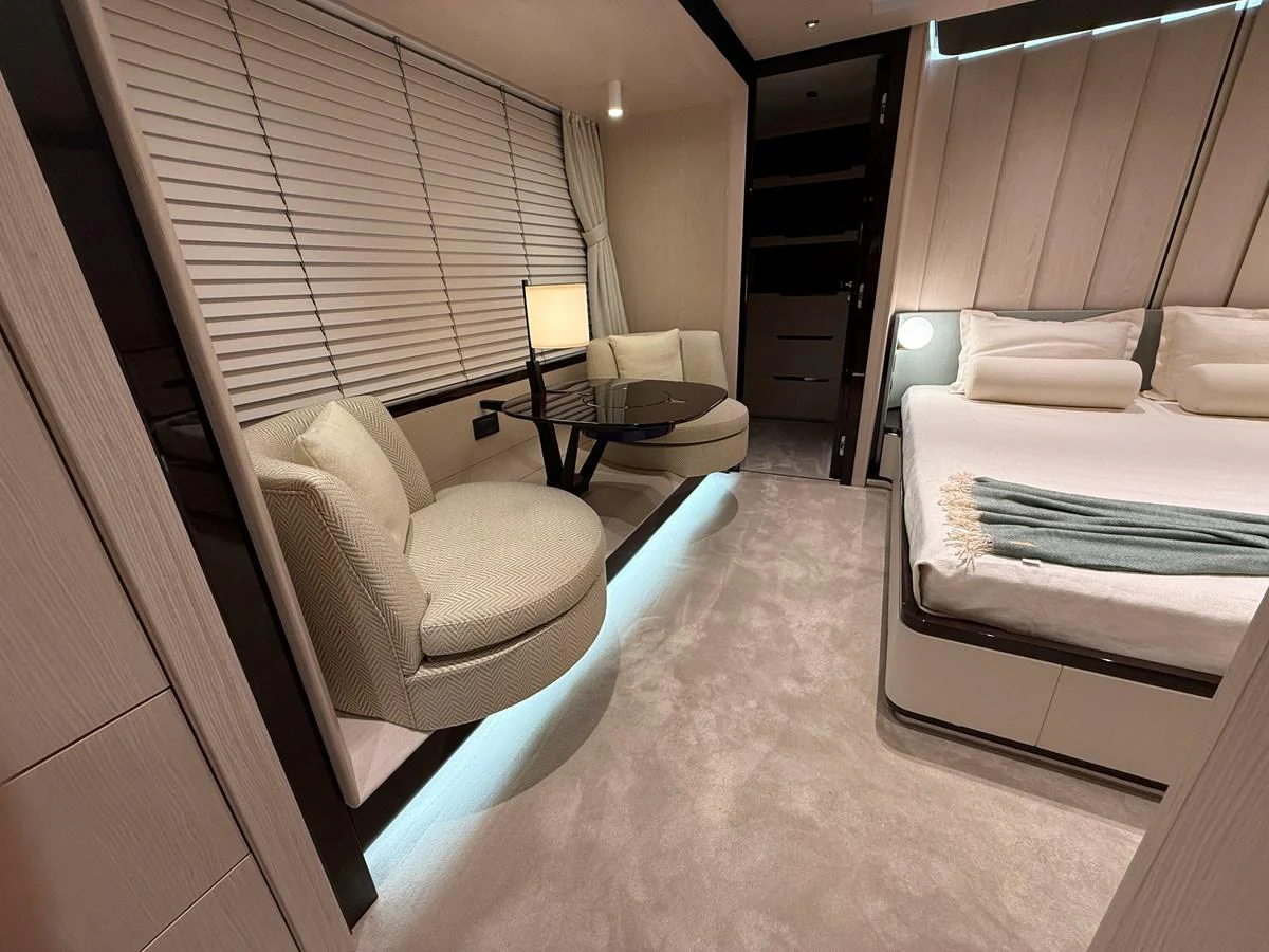 The stateroom features a plush bed, cozy seating area, and elegant lighting. aboard 2022 AZIMUT GRANDE 25M Yacht for Sale