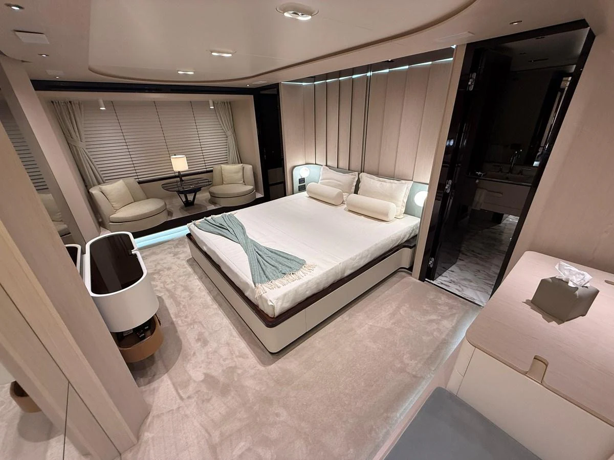 The master stateroom features a luxurious bed, elegant seating area, and modern decor. aboard 2022 AZIMUT GRANDE 25M Yacht for Sale