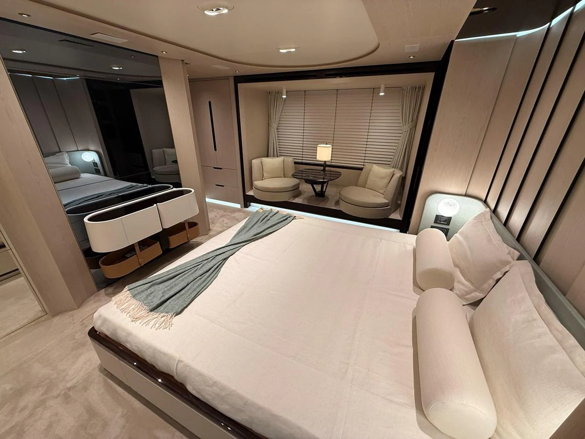The master stateroom features a luxurious bed with elegant furnishings and a cozy seating area. aboard 2022 AZIMUT GRANDE 25M Yacht for Sale