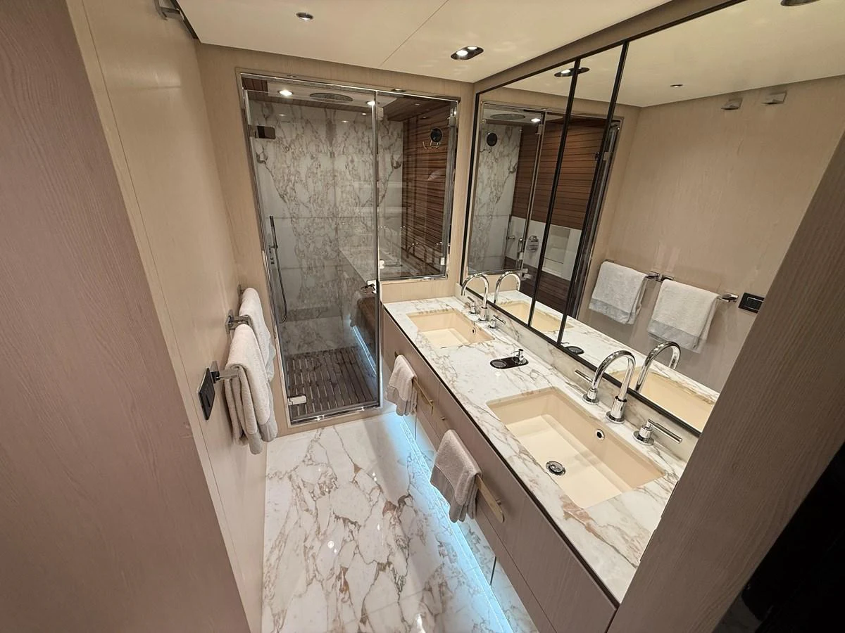 The yacht's bathroom features a luxurious design with marble countertops and a spacious shower. aboard 2022 AZIMUT GRANDE 25M Yacht for Sale