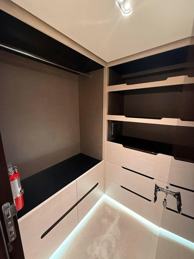 A well-organized storage area with ample shelving and drawers, featuring modern lighting. aboard 2022 AZIMUT GRANDE 25M Yacht for Sale