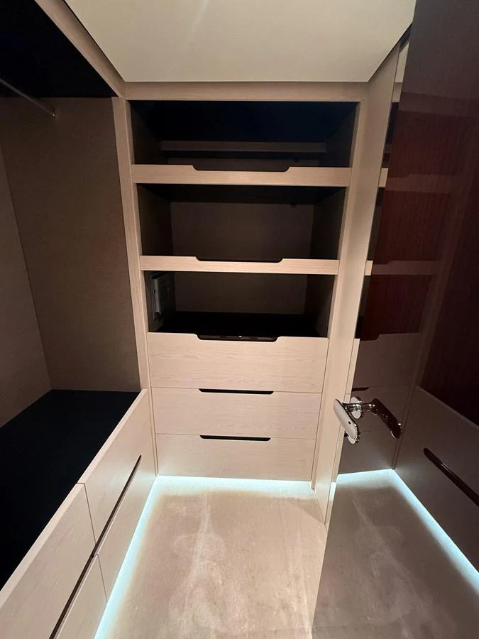 A well-organized closet with ample storage space and modern lighting. aboard 2022 AZIMUT GRANDE 25M Yacht for Sale