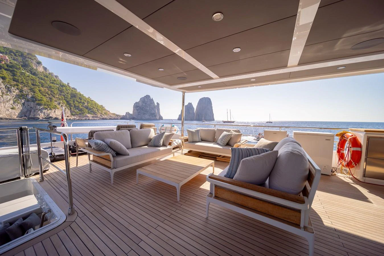 The aft deck offers a spacious and luxurious lounging area with stunning ocean views. aboard KAMOKA Yacht for Sale