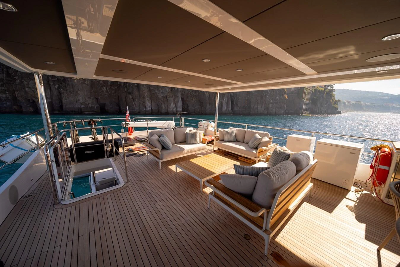 The aft deck offers a luxurious outdoor lounging area with comfortable seating and stunning views. aboard KAMOKA Yacht for Sale