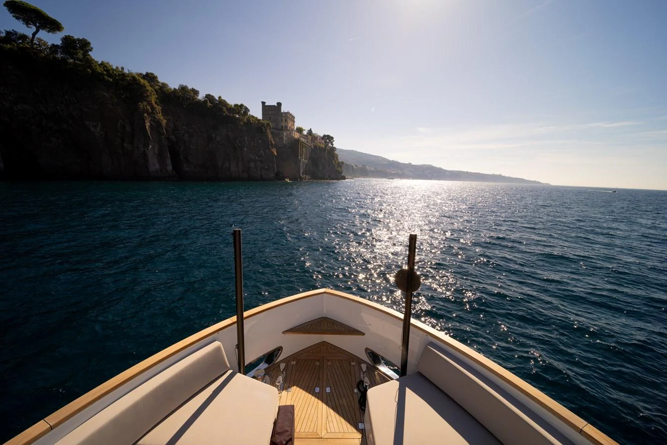 The yacht's bow offers a serene view of the coastline and sparkling waters. aboard KAMOKA Yacht for Sale