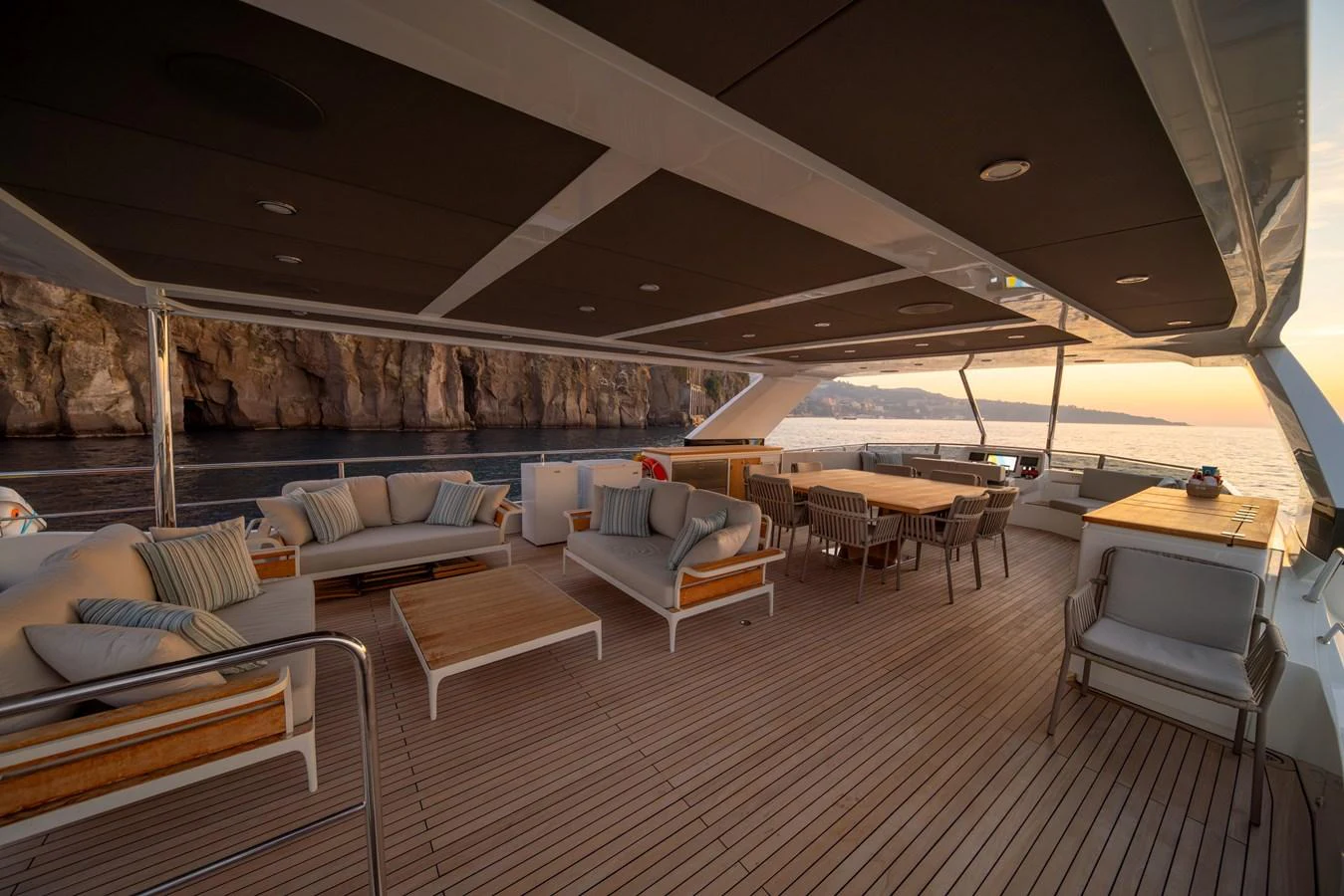The aft deck offers a spacious and elegant outdoor living area with comfortable seating and dining options, perfect for enjoying scenic views. aboard KAMOKA Yacht for Sale