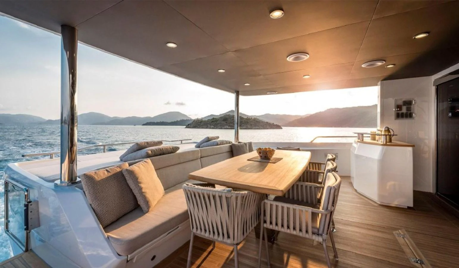 The aft deck offers a luxurious outdoor dining area with stunning sea views. aboard KAMOKA Yacht for Sale