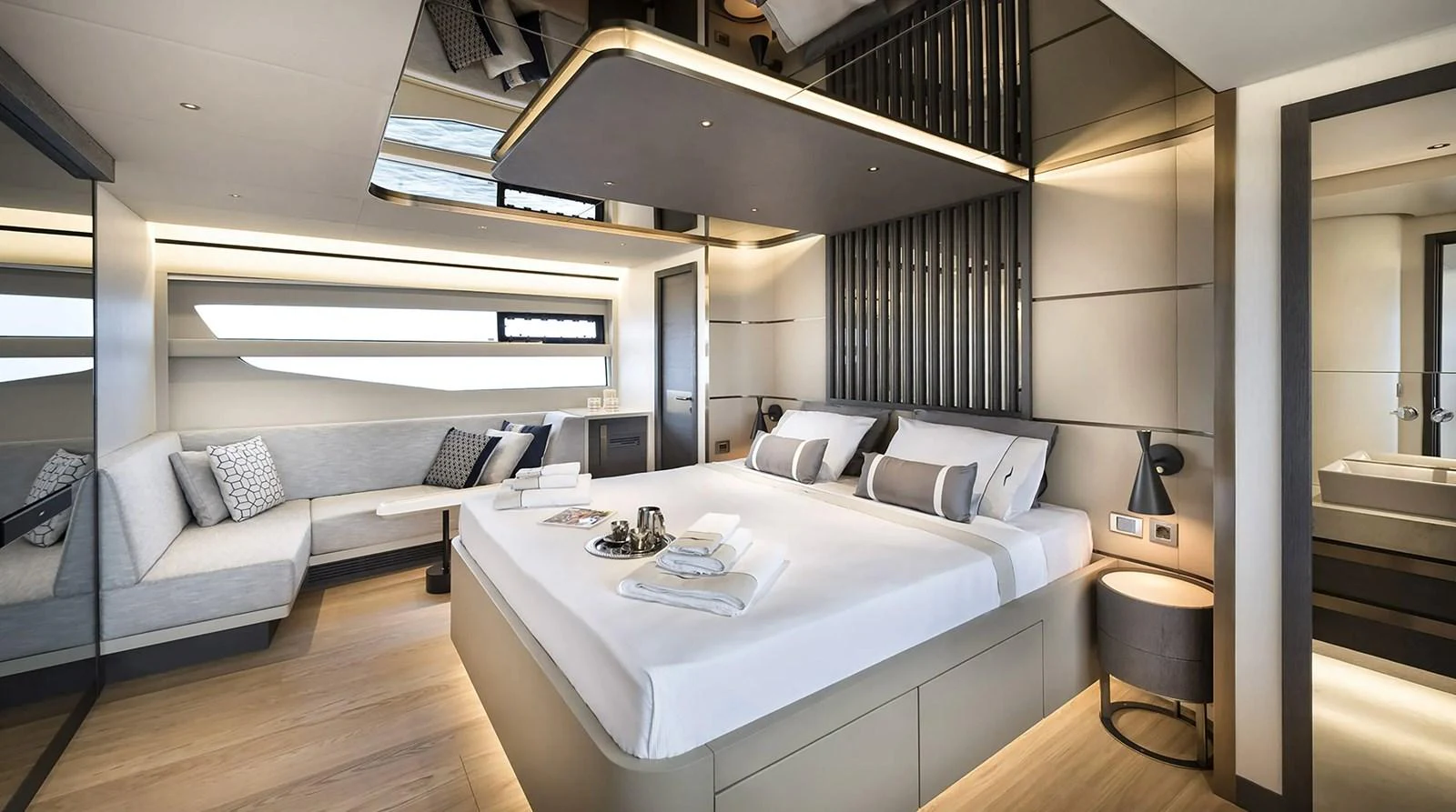 The master stateroom features a luxurious bed, modern decor, and ample natural light. aboard KAMOKA Yacht for Sale