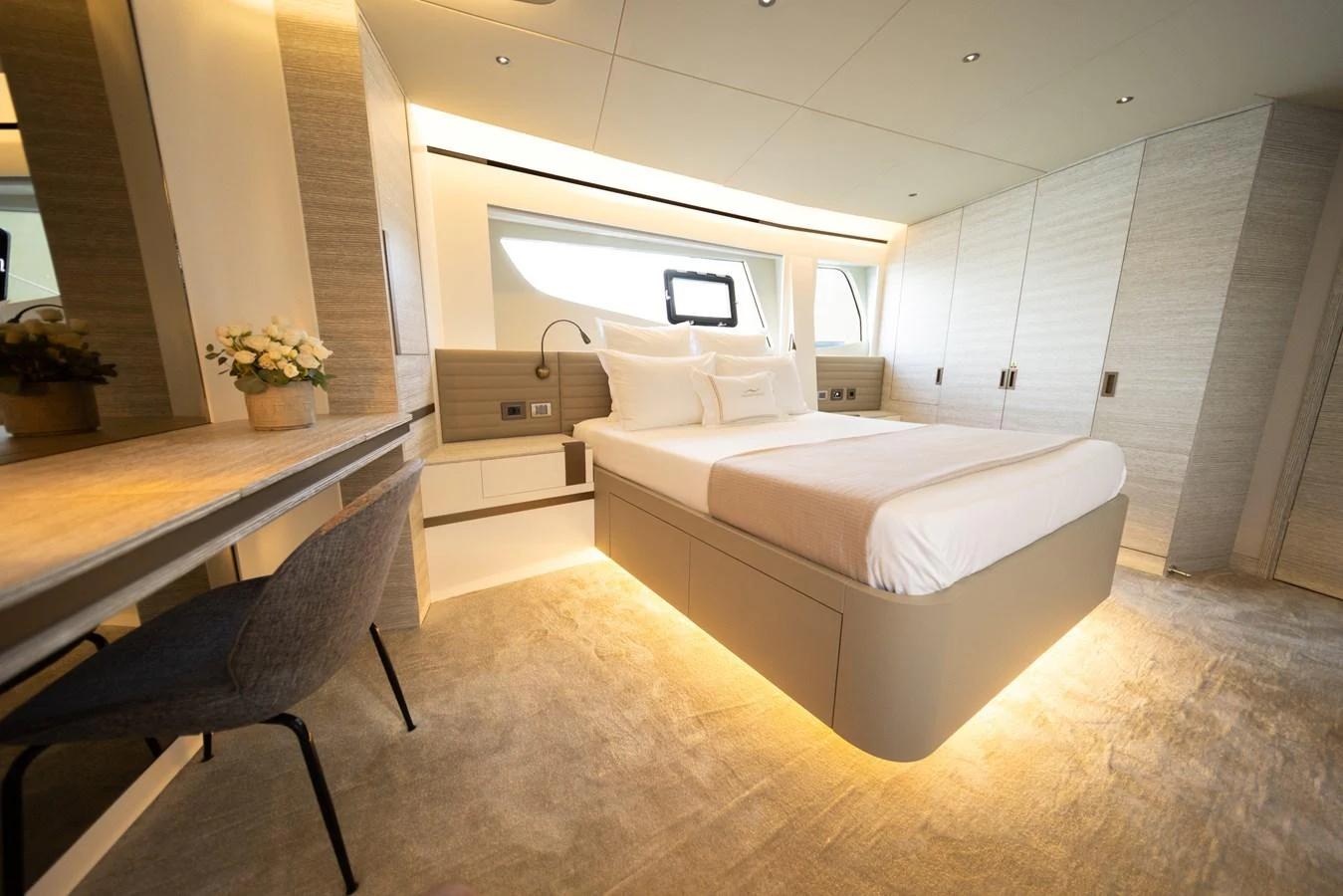 A luxurious stateroom featuring a modern design with elegant lighting and comfortable furnishings. aboard KAMOKA Yacht for Sale