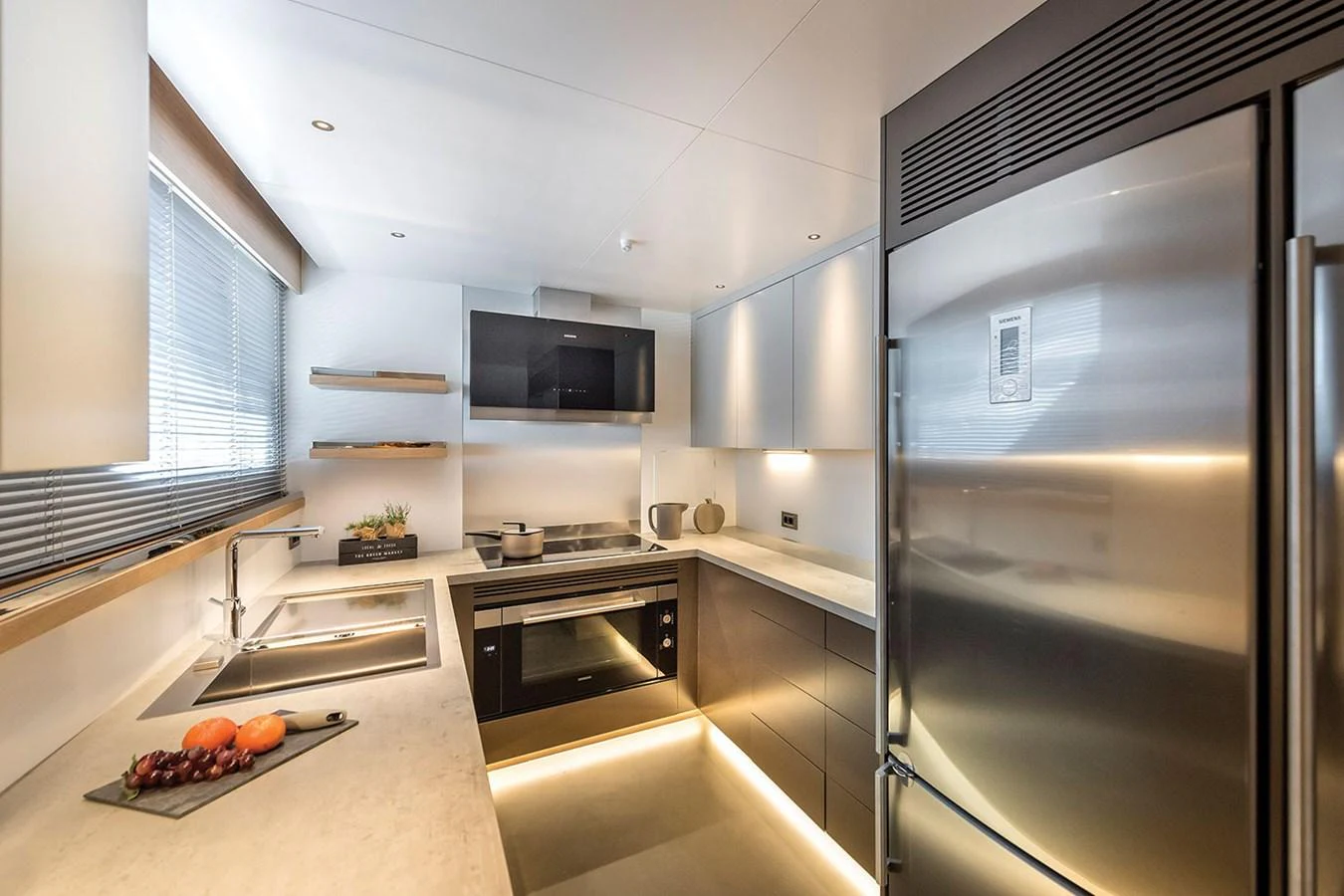 The modern galley features sleek appliances and ample counter space, perfect for gourmet cooking at sea. aboard KAMOKA Yacht for Sale
