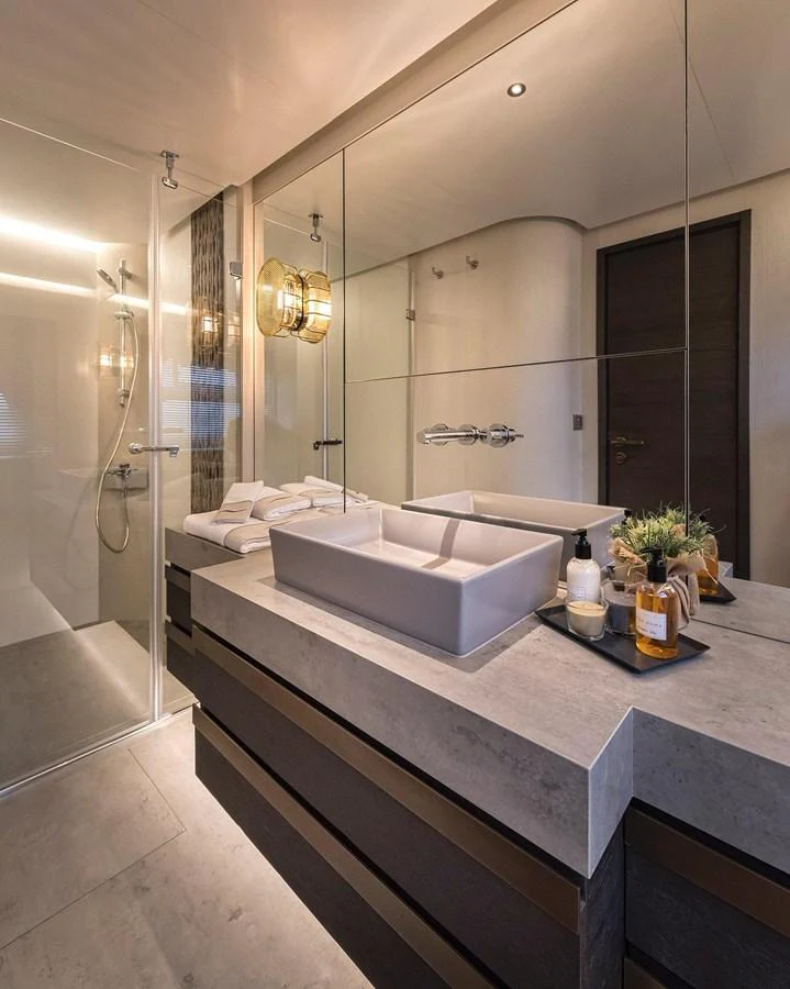 A modern and elegant yacht bathroom with a spacious shower and stylish fixtures. aboard KAMOKA Yacht for Sale