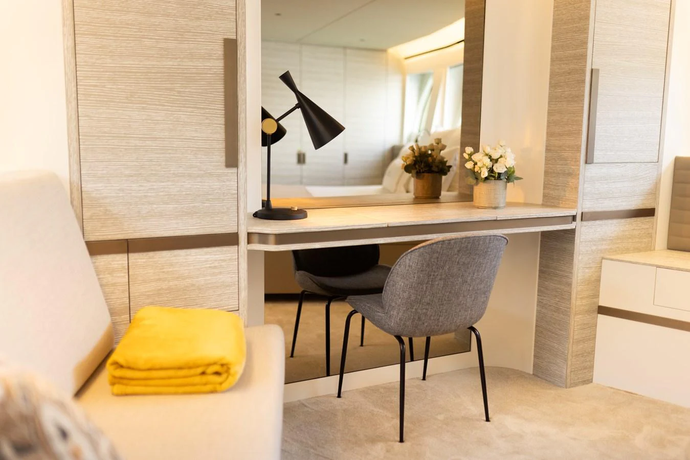 A cozy and modern workspace within the yacht's interior, featuring a sleek desk and comfortable chair. aboard KAMOKA Yacht for Sale