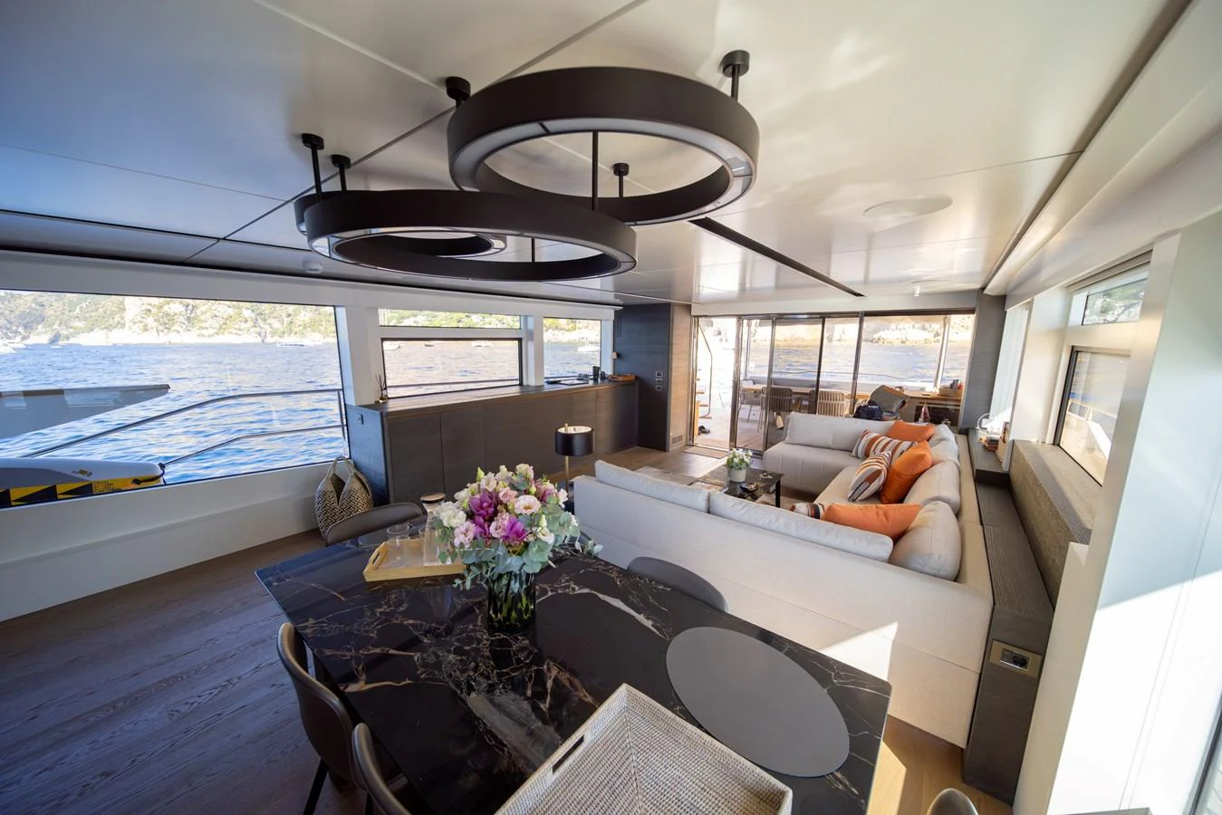 The salon features a spacious seating area with large windows offering stunning views. aboard KAMOKA Yacht for Sale