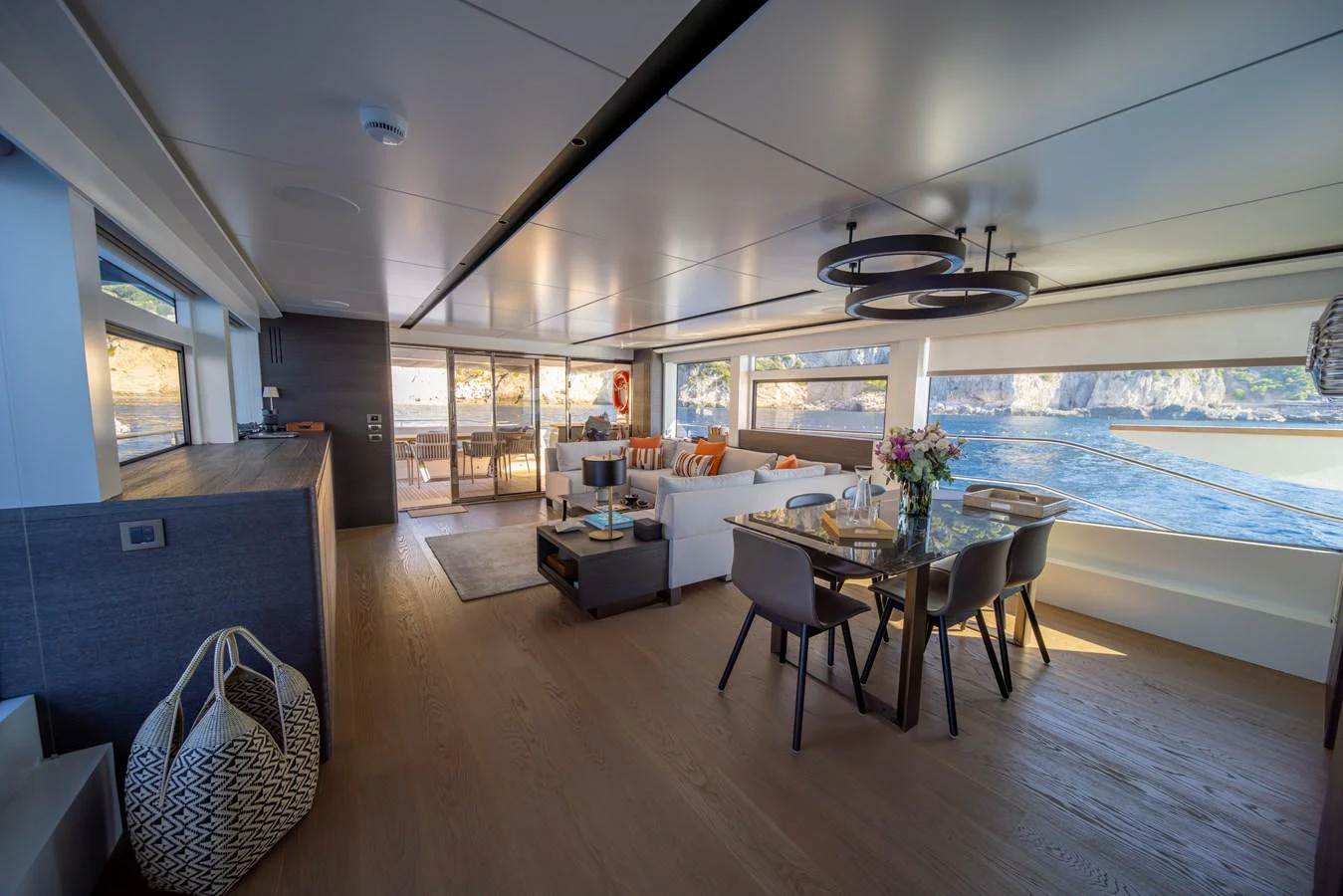 The salon offers a spacious and elegant living area with panoramic windows and modern furnishings. aboard KAMOKA Yacht for Sale