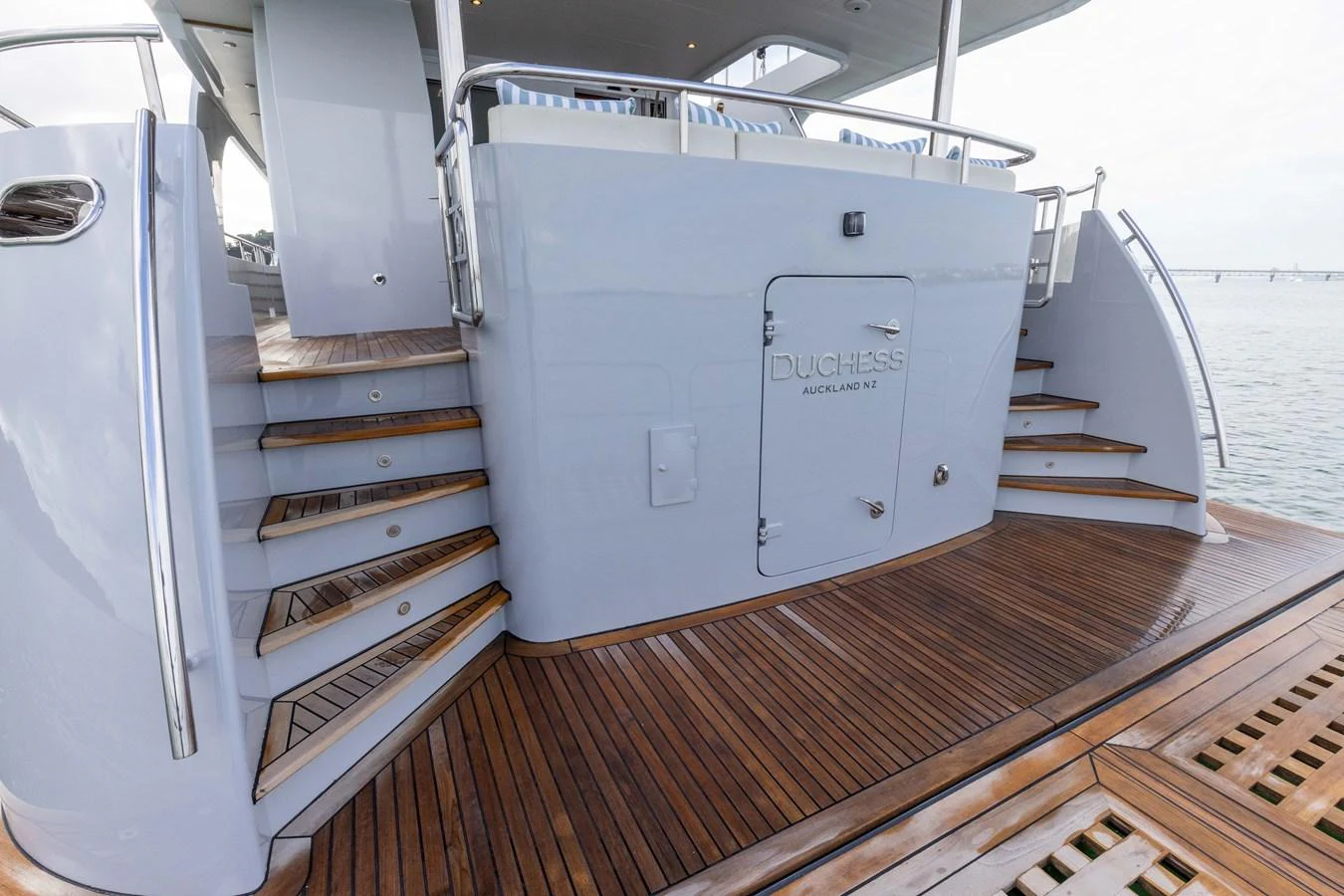 The aft deck features elegant wooden flooring and a sleek design, perfect for outdoor relaxation. aboard DUTCHESS Yacht for Sale