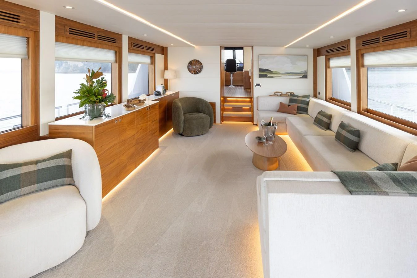 The salon features elegant seating, warm wood accents, and ample natural light. aboard DUTCHESS Yacht for Sale