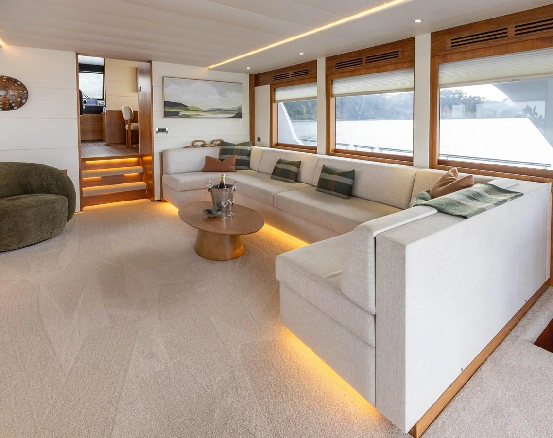 The salon features a spacious and elegantly designed seating area with modern furnishings and ambient lighting. aboard DUTCHESS Yacht for Sale