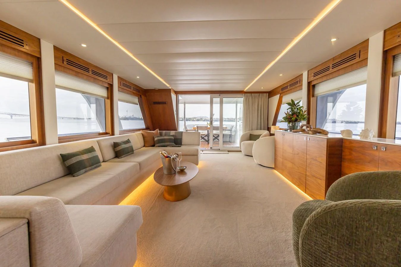 The salon features a spacious and elegant seating area with panoramic windows and modern decor. aboard DUTCHESS Yacht for Sale