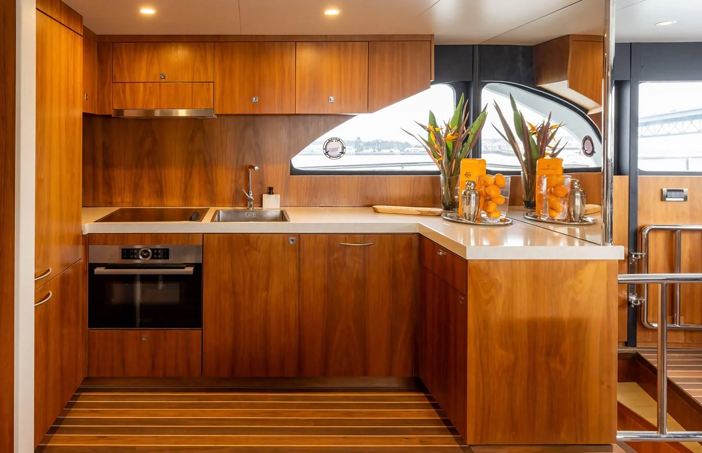 The galley features warm wood cabinetry, modern appliances, and ample counter space, creating a welcoming and functional cooking area. aboard DUTCHESS Yacht for Sale
