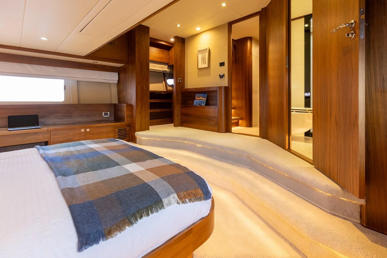 The master stateroom features elegant wood finishes and a cozy ambiance. aboard DUTCHESS Yacht for Sale