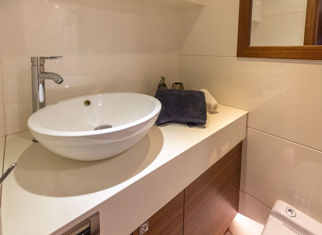 The yacht's bathroom features a modern sink and sleek fixtures. aboard DUTCHESS Yacht for Sale