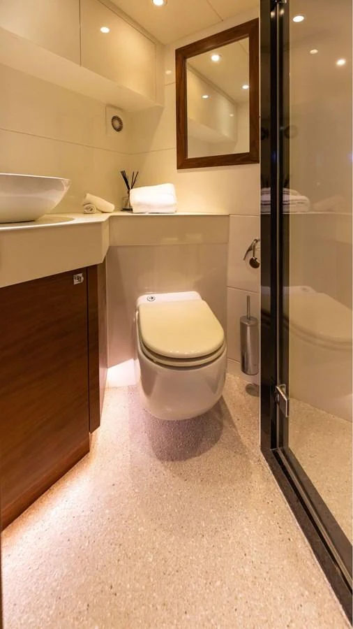 The yacht's bathroom features modern fixtures and a clean, elegant design. aboard DUTCHESS Yacht for Sale