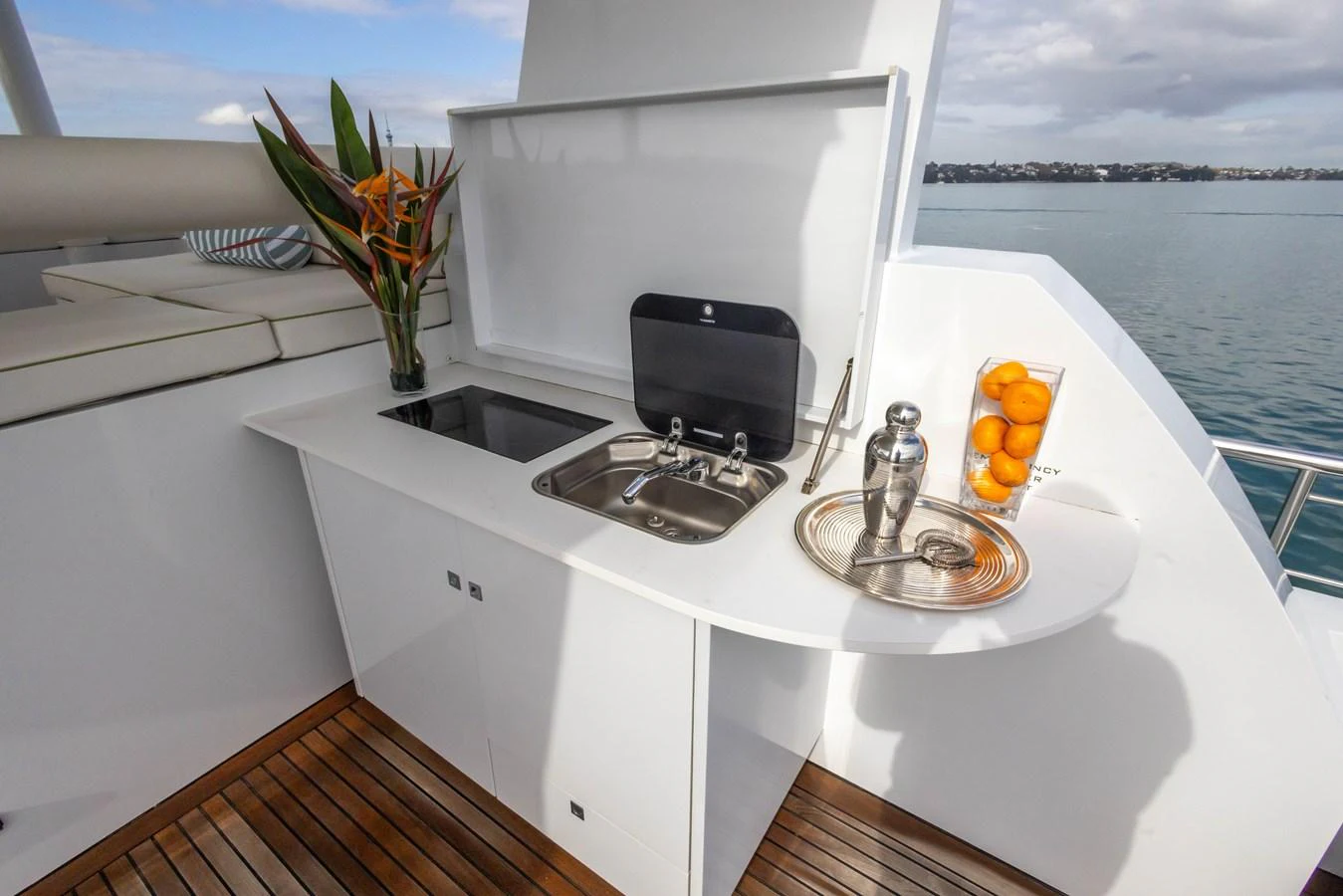 The yacht features a sleek outdoor galley with a sink, countertop, and elegant decor, perfect for alfresco dining. aboard DUTCHESS Yacht for Sale