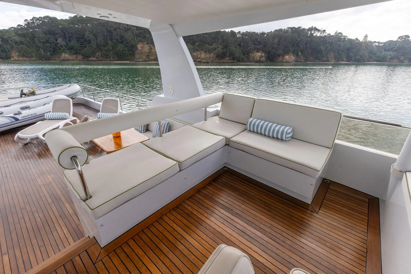 The aft deck features a comfortable seating area with a scenic view of the water and surrounding landscape. aboard DUTCHESS Yacht for Sale