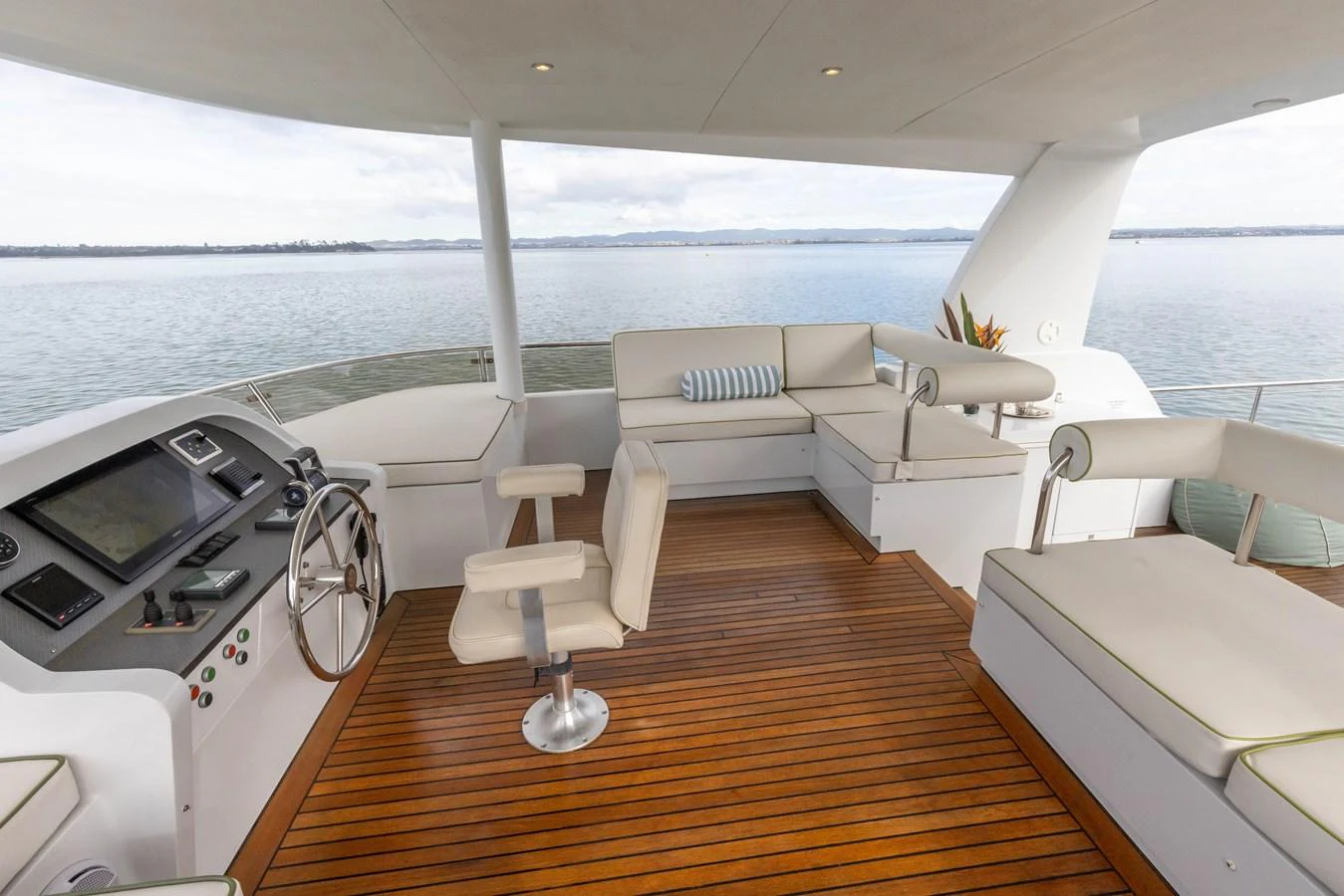 The flybridge offers a spacious and comfortable area with ample seating and a helm station, perfect for enjoying the view while cruising. aboard DUTCHESS Yacht for Sale