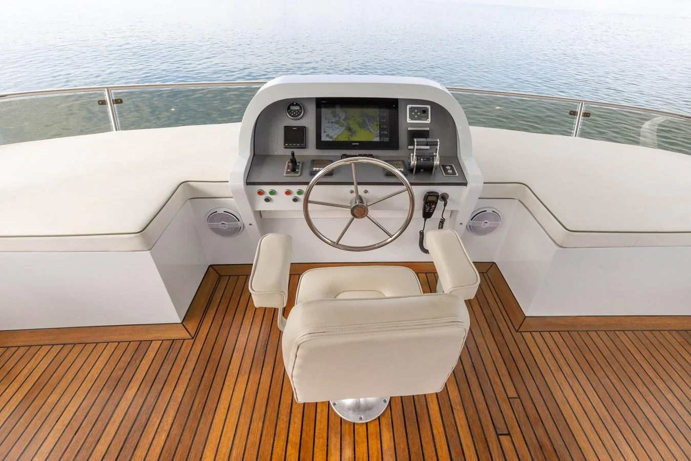 The helm station features a sleek design with a comfortable captain's chair and advanced navigation equipment. aboard DUTCHESS Yacht for Sale