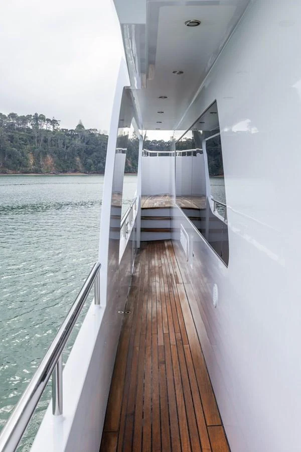 The sleek side deck of the yacht offers a serene view of the surrounding waters. aboard DUTCHESS Yacht for Sale