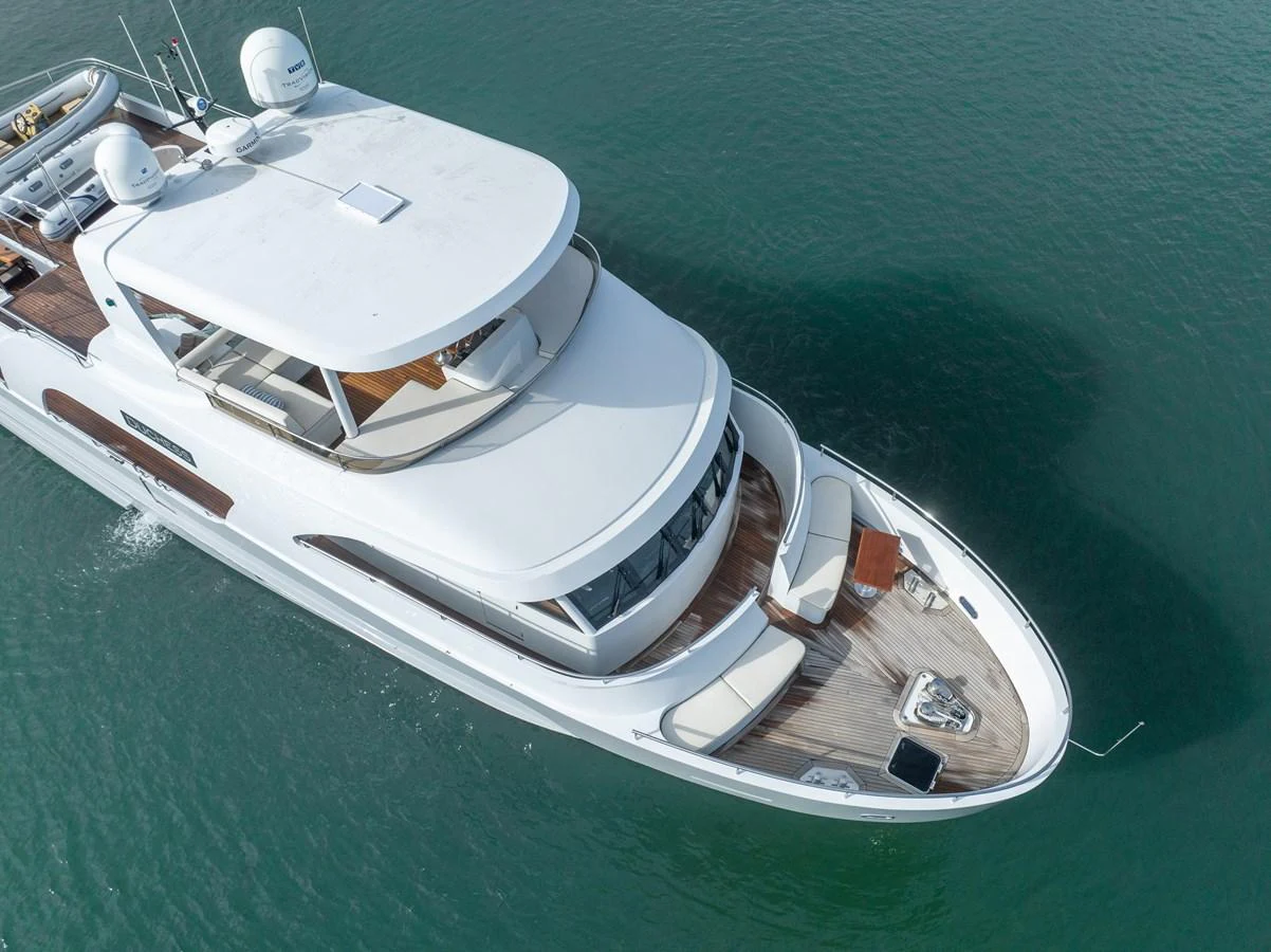 A sleek and modern yacht glides gracefully over calm waters, showcasing its elegant design and spacious decks. aboard DUTCHESS Yacht for Sale