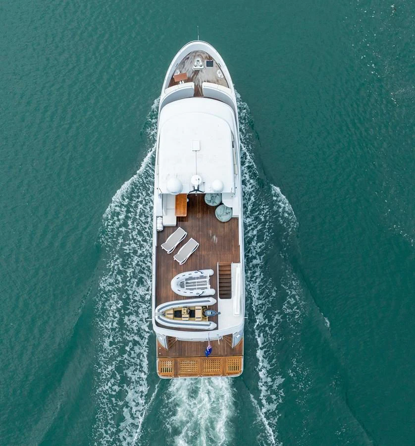 Aerial view of a luxurious yacht cruising through calm waters, showcasing its sleek design and spacious deck. aboard DUTCHESS Yacht for Sale