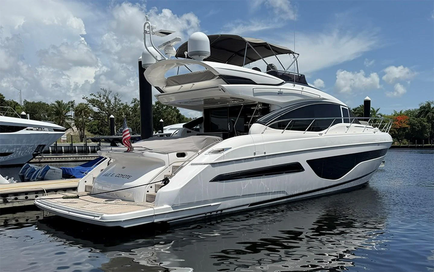 A sleek and modern yacht docked at a marina, showcasing its elegant lines and spacious decks. aboard WILE E COYOTE Yacht for Sale