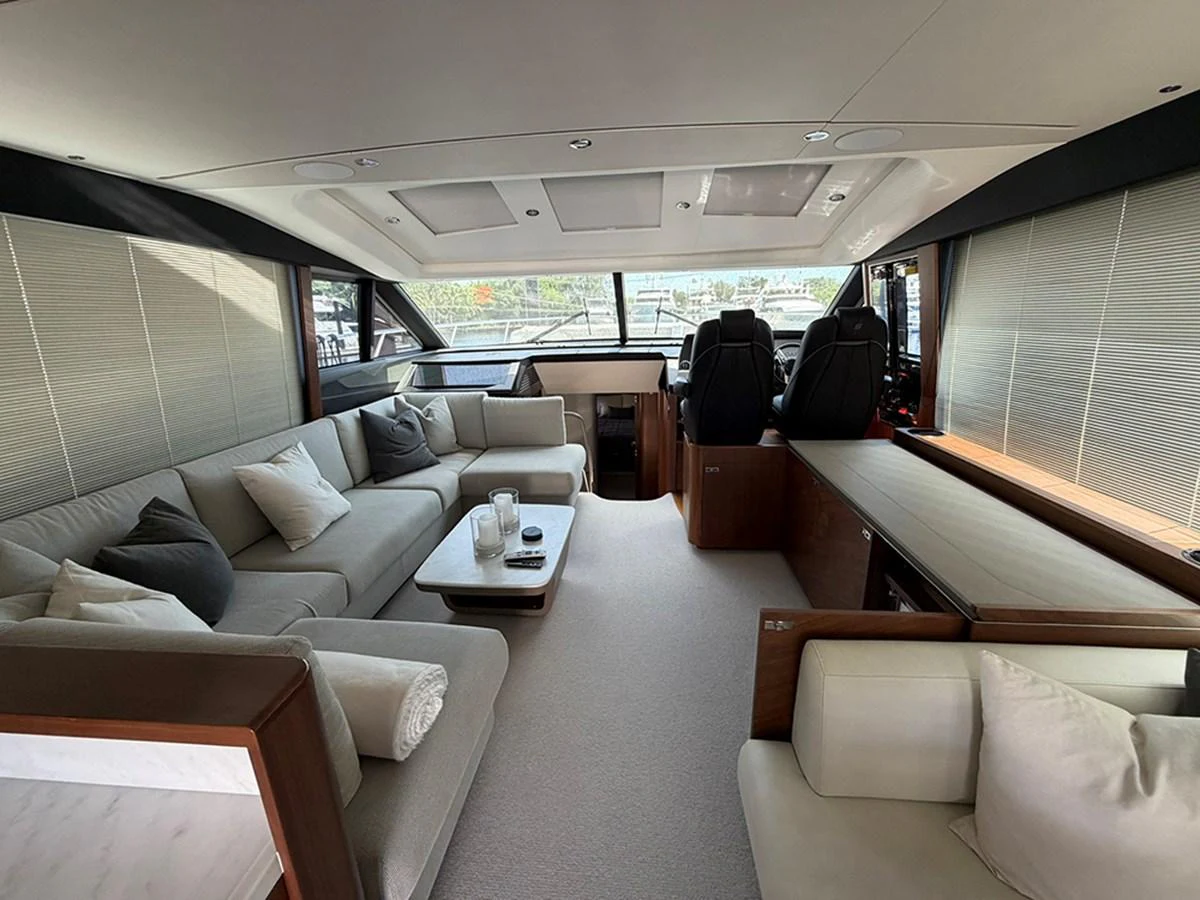 The salon features plush seating and large windows, offering a comfortable and bright living space. aboard WILE E COYOTE Yacht for Sale