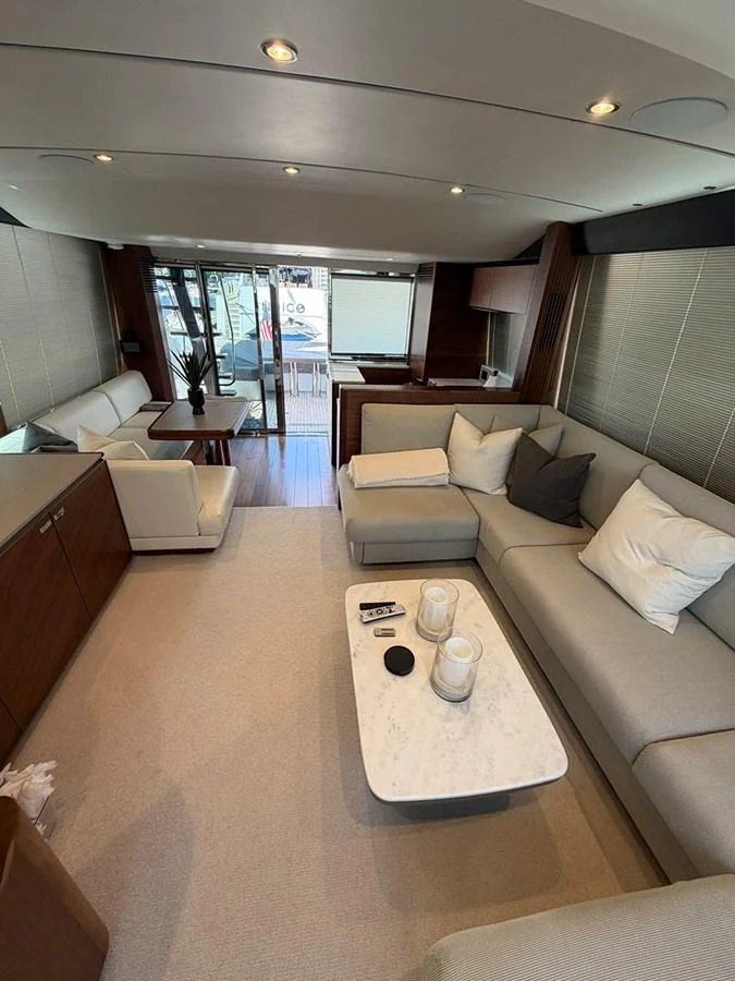 The salon features a comfortable seating area with modern decor and ample natural light. aboard WILE E COYOTE Yacht for Sale