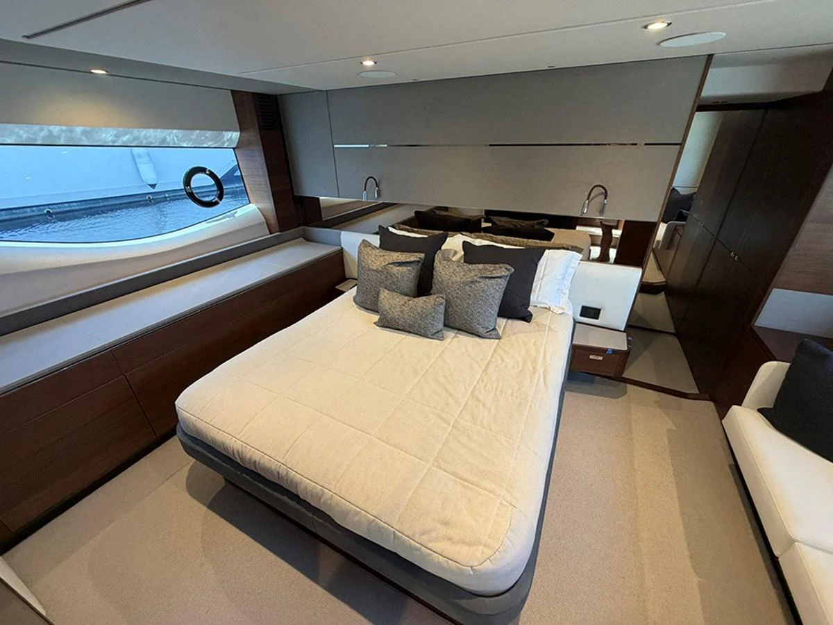 The stateroom features a luxurious bed with plush pillows and modern decor. aboard WILE E COYOTE Yacht for Sale