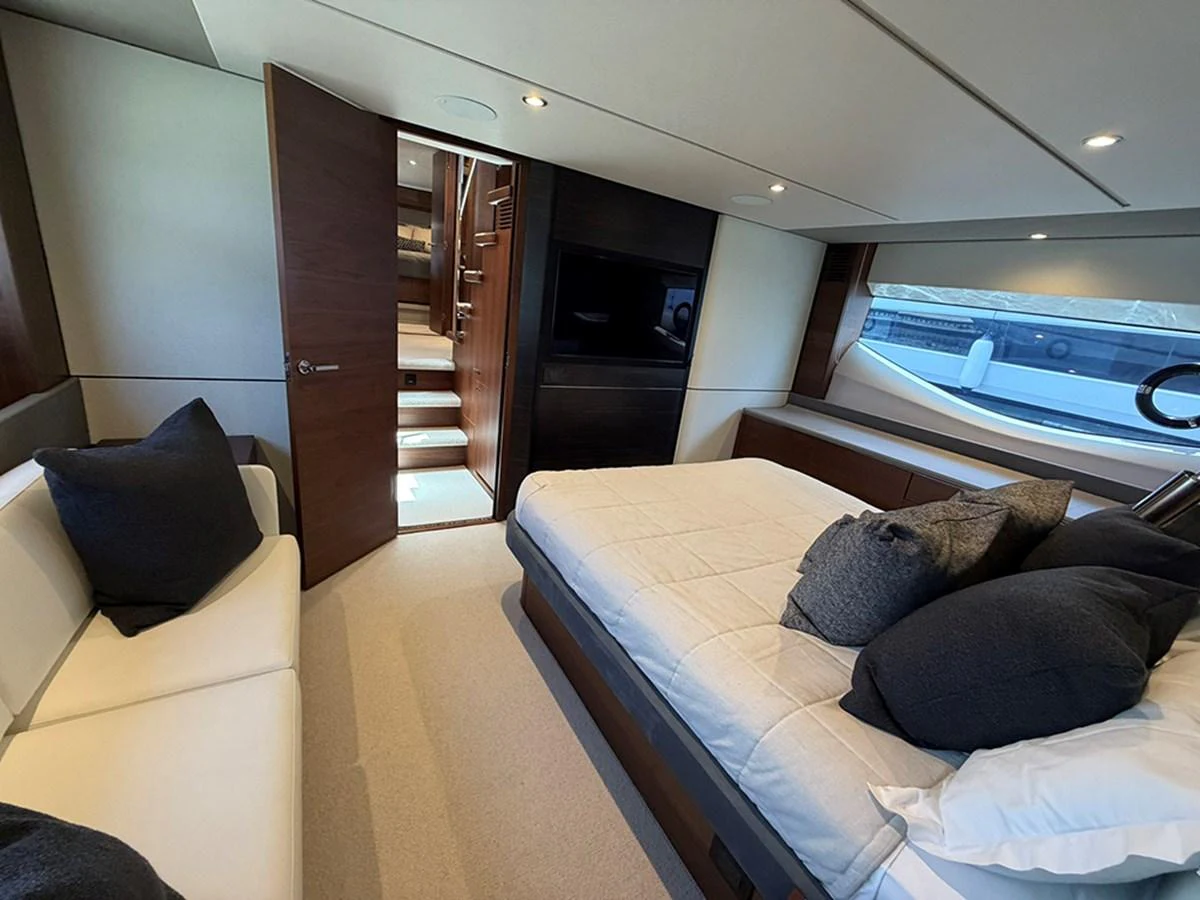 A luxurious stateroom featuring a comfortable bed, modern decor, and ample natural light. aboard WILE E COYOTE Yacht for Sale