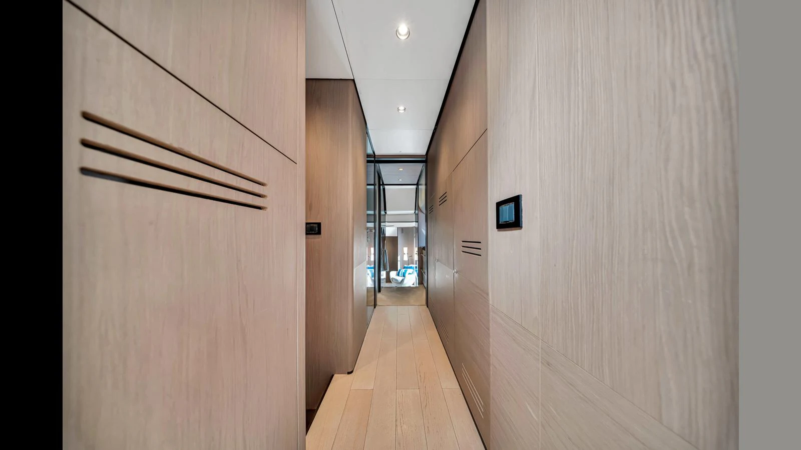 A sleek and modern hallway with wooden paneling and recessed lighting. aboard CLOUD 9 Yacht for Sale