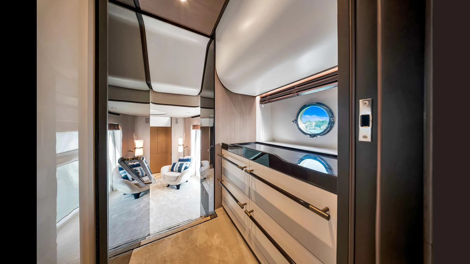 A luxurious hallway leads to a spacious and elegantly furnished living area with a large window offering a scenic view. aboard CLOUD 9 Yacht for Sale
