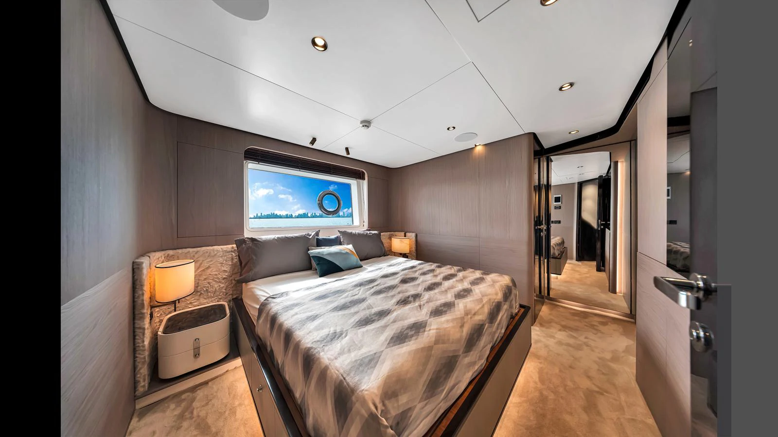 A luxurious stateroom featuring a large bed, modern decor, and ample natural light. aboard CLOUD 9 Yacht for Sale