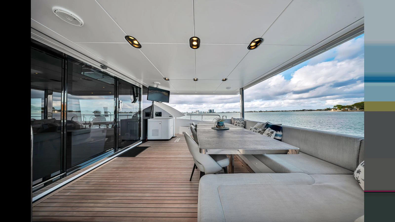 The aft deck offers a spacious and elegant outdoor dining area with stunning views of the water. aboard CLOUD 9 Yacht for Sale