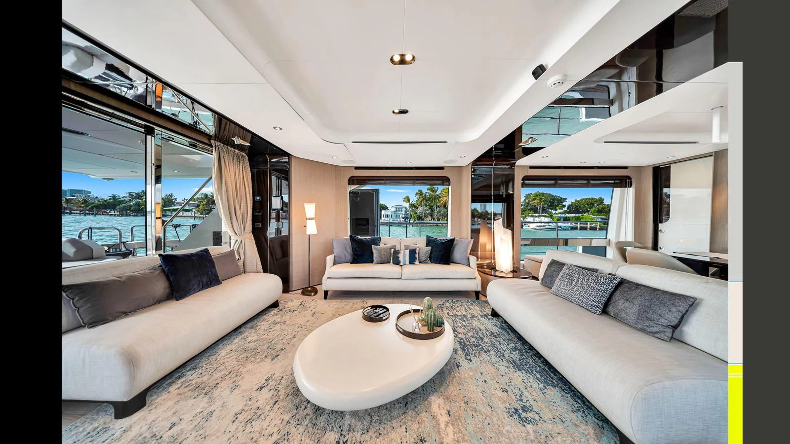 The salon features luxurious seating with a modern design and large windows offering stunning views. aboard CLOUD 9 Yacht for Sale
