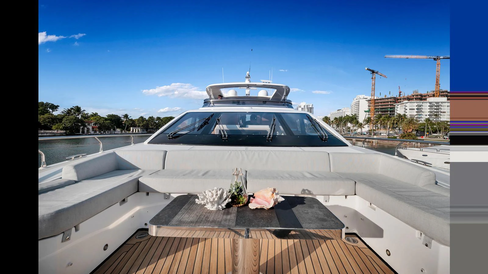 The aft deck features a spacious seating area with a central table, perfect for outdoor relaxation and dining. aboard CLOUD 9 Yacht for Sale