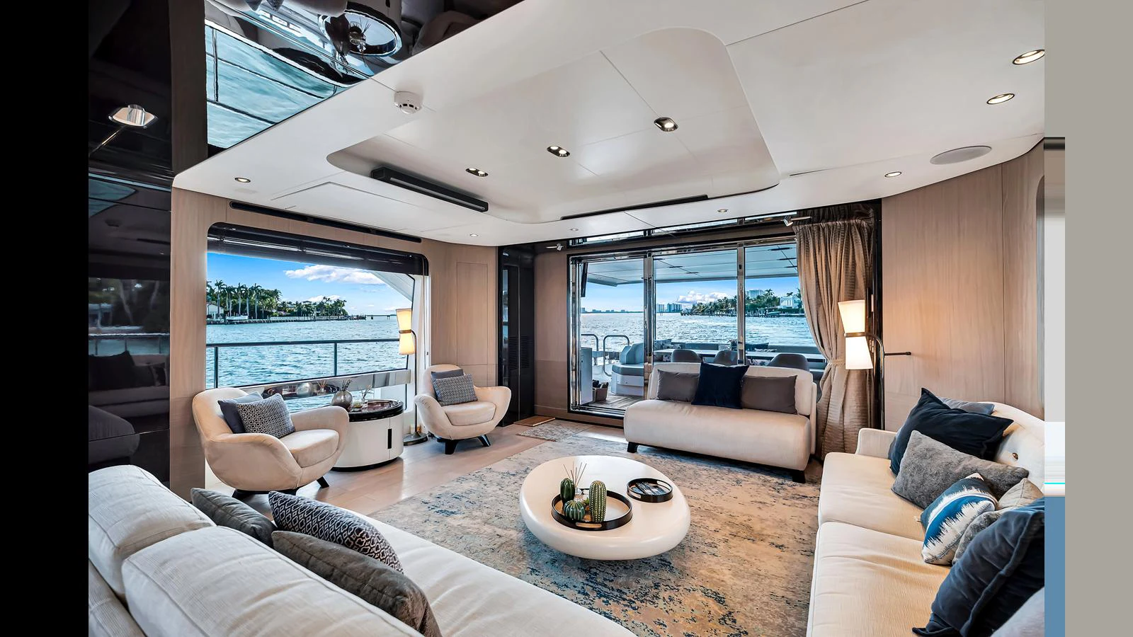 The yacht's salon features luxurious seating with a panoramic view of the water. aboard CLOUD 9 Yacht for Sale