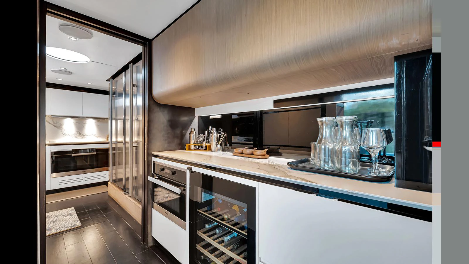 The yacht's galley is equipped with modern appliances and sleek cabinetry, offering a stylish and functional space for meal preparation. aboard CLOUD 9 Yacht for Sale