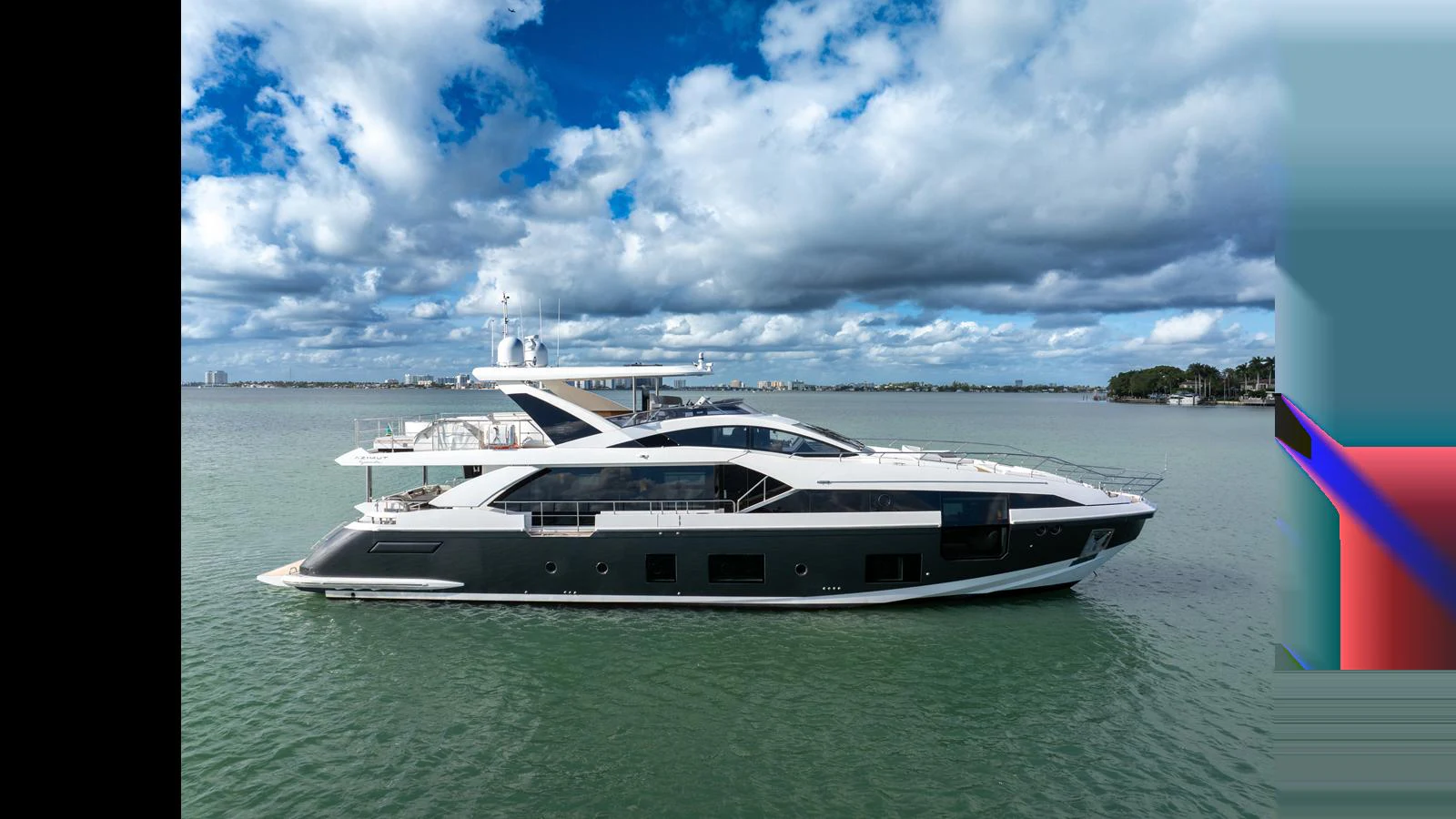 A sleek and modern yacht cruises on calm waters under a partly cloudy sky. aboard CLOUD 9 Yacht for Sale