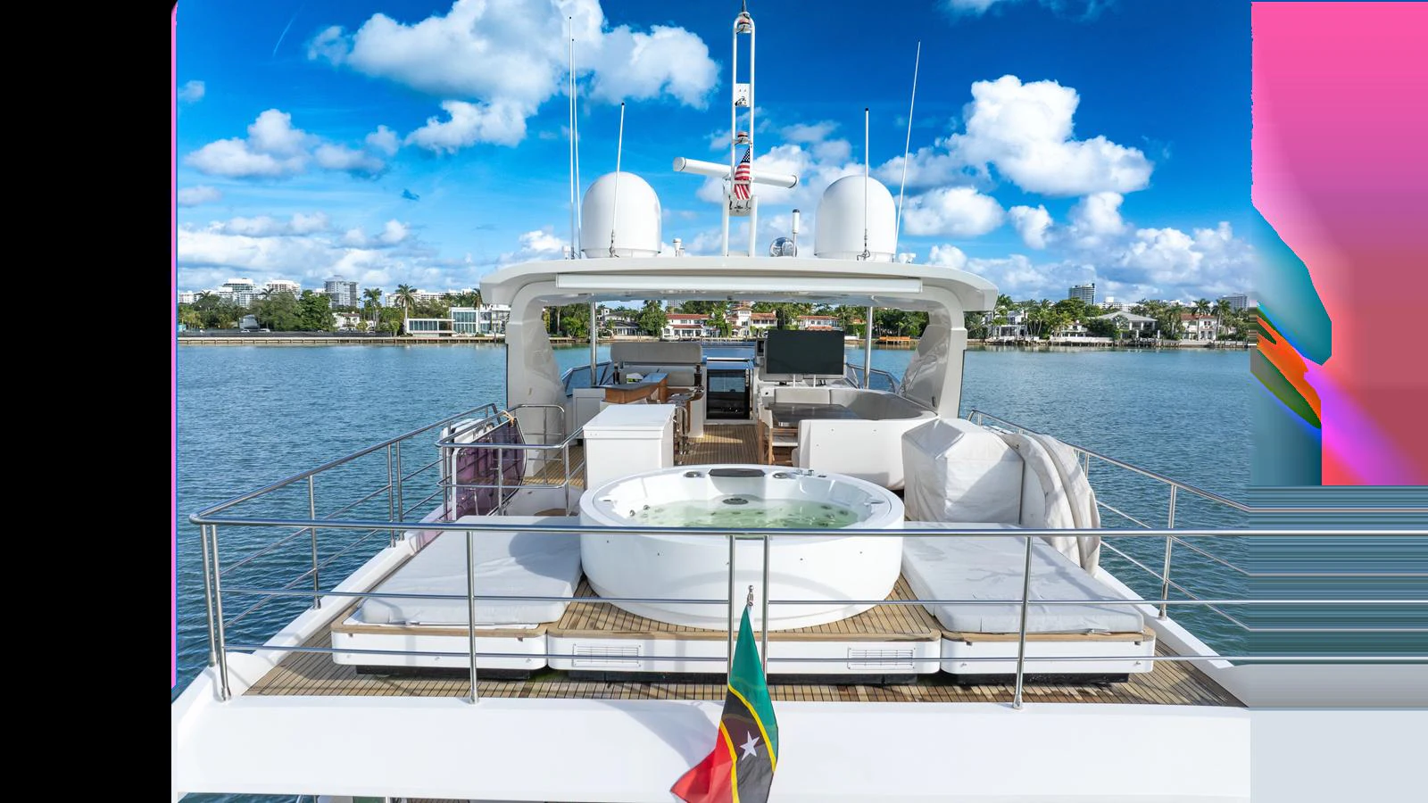 The aft deck features a luxurious hot tub surrounded by comfortable seating, perfect for relaxation and enjoying the view. aboard CLOUD 9 Yacht for Sale