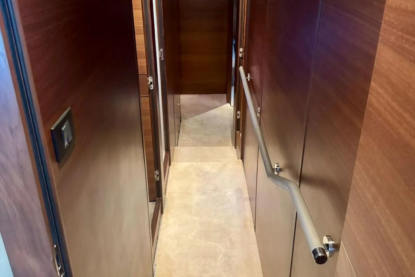 A sleek hallway with wooden paneling and a sturdy handrail. aboard LADY N Yacht for Sale