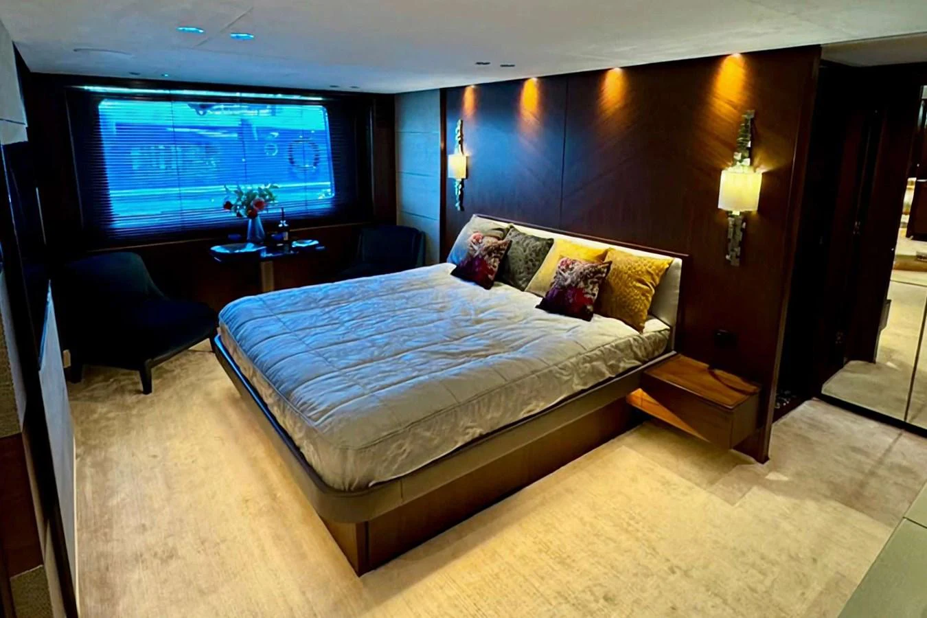 The master stateroom features a luxurious bed with elegant lighting and modern decor. aboard LADY N Yacht for Sale